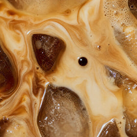 Milk swirling into iced protein coffee