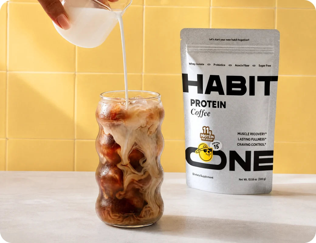 Pouring cream into HabitONE iced protein coffee