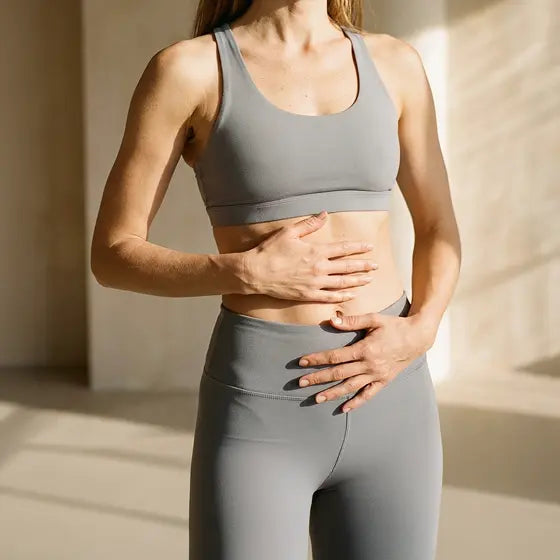 Woman holding her bloated belly