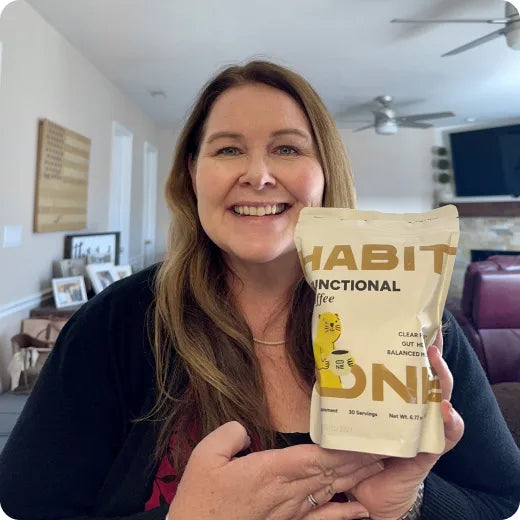Woman holding a pack of HabitONE functional coffee